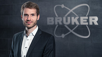 Dr. Adrian Fiege als Gast dieses Future For Geos vor dem Logo des Analytik-Herstellers Bruker